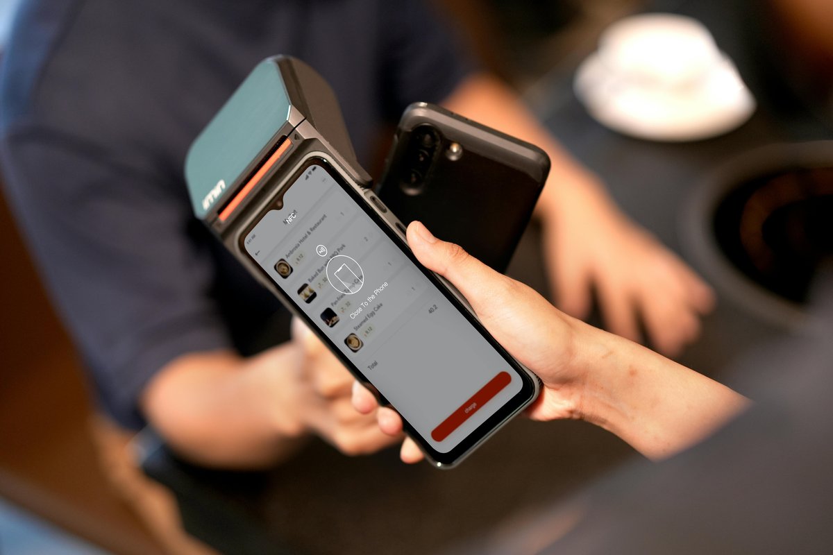 Server taking an order at the table on the Andromeda OrderPad handheld